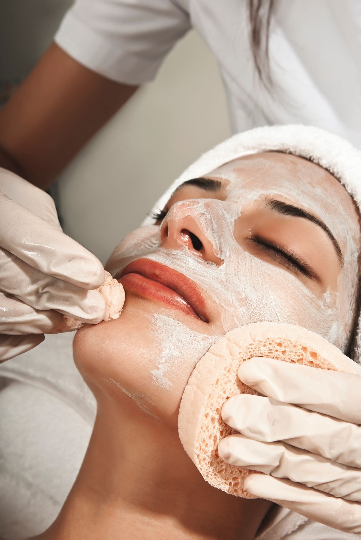 Skin care concept. Woman getting facial with a professional. 